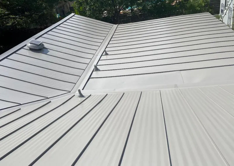 Solar attic fan installed on a metal roof for Roof Ventilation in Poolesville
